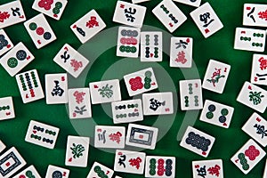 White-green tiles for mahjong on on green cloth background