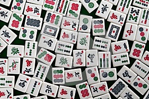 White-green tiles for mahjong on on green cloth background