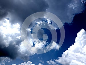 White grey and black, fluffy clouds in blue sky. Blue sky with clouds, White clouds on blue sky background close up