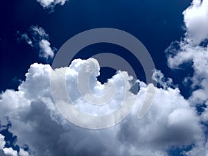 White grey and black, fluffy clouds in blue sky. Blue sky with clouds, White clouds on blue sky background close up