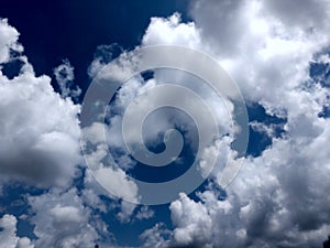 White grey and black, fluffy clouds in blue sky. Blue sky with clouds, White clouds on blue sky background close up