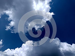 White grey and black, fluffy clouds in blue sky. Blue sky with clouds, White clouds on blue sky background close up