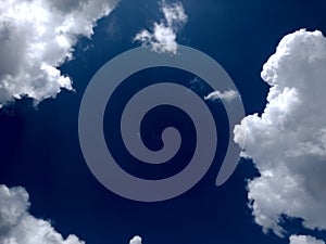 White grey and black, fluffy clouds in blue sky. Blue sky with clouds, White clouds on blue sky background close up