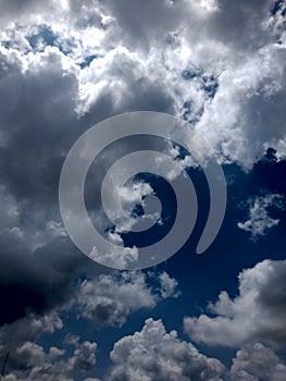 White grey and black, fluffy clouds in blue sky. Blue sky with clouds, White clouds on blue sky background close up