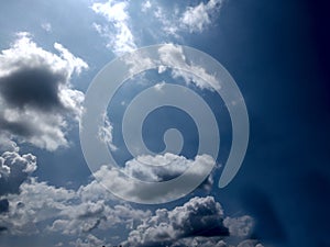 White grey and black, fluffy clouds in blue sky. Blue sky with clouds, White clouds on blue sky background close up