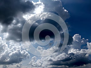 White grey and black, fluffy clouds in blue sky. Blue sky with clouds, White clouds on blue sky background close up