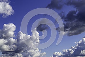 White and grey clouds in sunny sky. Contrast bright background