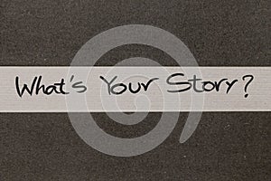 White and Grey coloured paper background with Whats Your Story motivational message