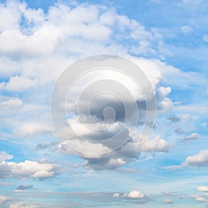 White and grey cumulus clouds in blue autumn sky