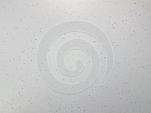 White and grey surface or wall with speckles or dots