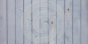 White grey wood texture Weathered Wooden Plank Barn Siding Background with Rusty Nail heads