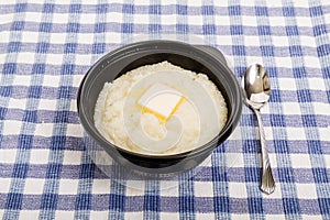 White Grits in Black Bowl with Butter