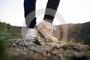 The white grunge shoes on the rock in park