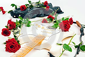 White guitar on the floor. Red roses. Leather Jacket. Romantic music