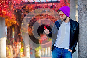 White guy using a mobile phone in a park