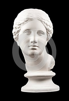 Gypsum copy of ancient statue Venus head isolated on black background. Plaster sculpture woman face.