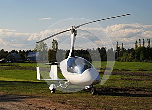 White gyroplane parked on the private airfield photo