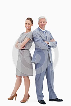 White hair businessman back to back with a woman and smiling