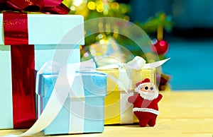 white hair  Santa Claus and christmas gift box with red ribbon on christmas tree and abstract bokeh glitter background