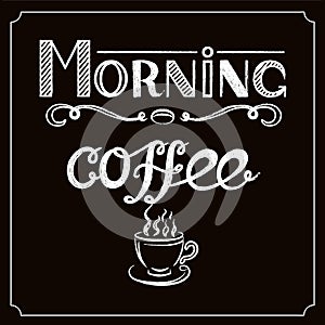 White Hand drawn lettering `Morning coffee` with charcoal effect and view of a cup of coffee on black background.