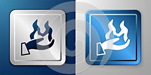 White Hand holding a fire icon isolated on blue and grey background. Silver and blue square button. Vector