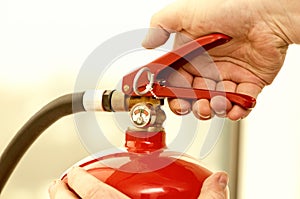 Hand presses the trigger fire extinguisher