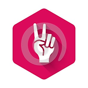 White Hand showing two finger icon isolated with long shadow background. Hand gesture V sign for victory or peace. Pink