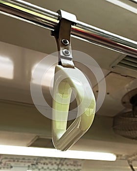 White handgrip passenger pull handle on the train