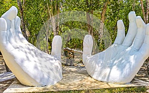 White hands sculpture figure in tropical jungle near cenote Mexico