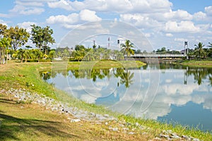 White hanging bridge of Nong Prajak Park and blue sky with clouds,