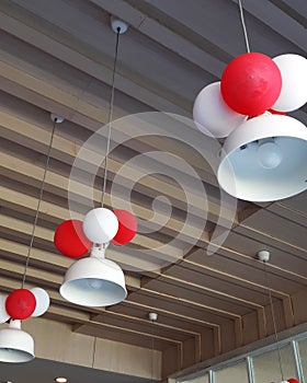 White hanging lamps decorated with red and white balloons
