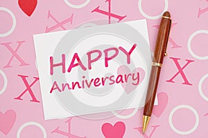 White Happy Anniversary greeting card on pink love paper