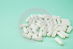 White hard capsules isolated on green - medical