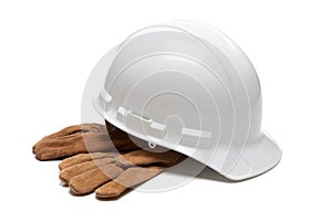 White hard hat and leather work gloves on white