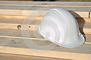 White Hard Hat on Lumber