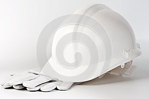 White hard hat and protection gloves