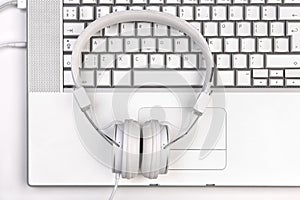White headfones on silver laptop.