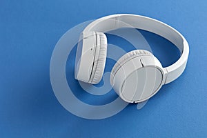 White headphones on blue background