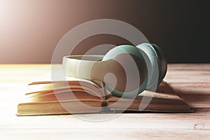 White headphones on the book and a magnifier