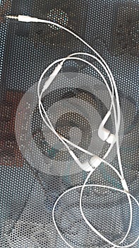 White headphones with headset lying on black background