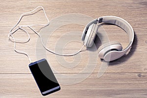 White headphones and mobile phone on a table music listen lover earphones hobby free time rest relax pause leisure break meloman t photo