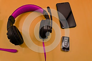 White headphones and smart phone on wooden table