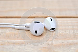 White headphones on wood table