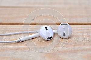 White headphones on wooden table