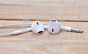 White headphones on wooden table