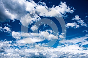 White heap clouds in the blue sky. Cloudscape over horizon. Heaven