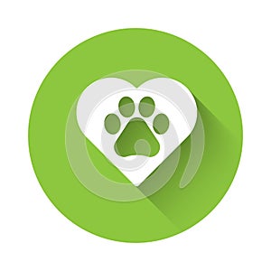 White Heart with animals footprint icon isolated with long shadow. Pet paw in heart. Love to the animals. Green circle