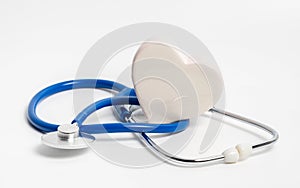 White heart and blue stethoscope on white background. Concept of heart check or cardiology treatment of cardiovascular