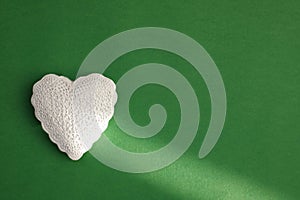 White heart on green background. Valentine`s day, anniversary, mother`s day, marriage concept, invitation e-card