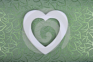 White heart on green textured floral background